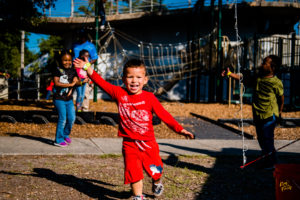 Children celebrating at the Green Heart Harvest Dinner, a community event supported by Christmas Injury