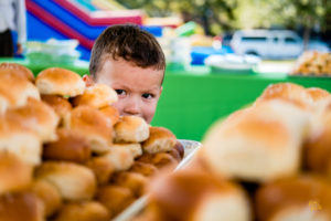 Young boy looking at a display of freshly baked rolls at the Green Heart Harvest