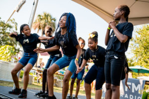 Students performing at the 9th Annual Green Heart Harvest Dinner, supported by Christmas Injury Lawyers