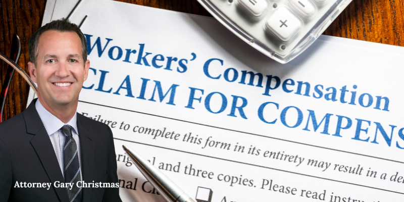 Attorney Gary Christmanal of Christmas Injury Lawyers, smiling, with a workers’ compensation claim form and
