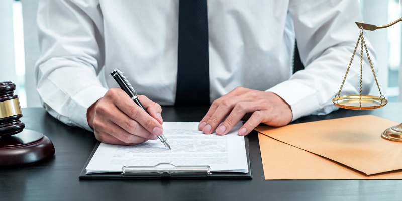 Christmas Injury Lawyers attorney signing legal documents, demonstrating trial-ready representation for personal injury cases in