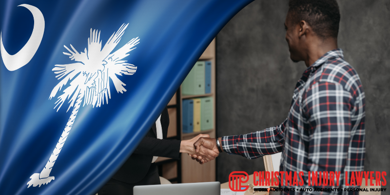 A person shaking hands with a lawyer in front of the South Carolina flag, symbolizing