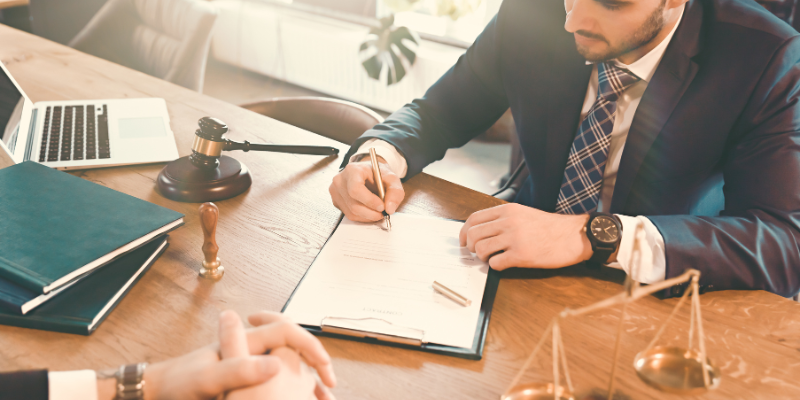Attorney consulting with a client in a law office, discussing pedestrian accident legal rights and